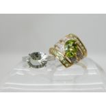A 9ct gold peridot and diamond dress ring size Q1/2 and a 9ct white gold pale blue gemstone ring,