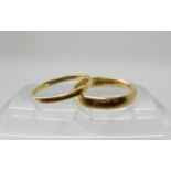 An 18ct court wedding ring size L1/2, together with a thinner example size L1/2, combined weight 4.