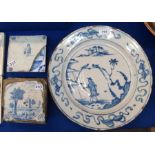 A Delft tin glazed charger, decorated in blue in the oriental style, 34.5cm wide, (cracked and