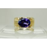 An 18ct gold tanzanite set gents ring, tanzanite approx 11.8mm x 9mm, weight 17.5gms, size V1/2