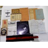 A lot comprising a WWII bombing angle computer, an RAFP arm band, map tablecloth, booklets of