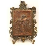 A brass framed mirror, with fold out panel, the front with relief copper panel depicting a