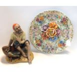 A Dresden figure of a fish seller signed to base together with an Italian floral wall charger