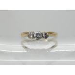 An 18ct gold and platinum three stone ring set with estimated approx 0.22cts, finger size M,