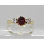 An 18ct ruby and diamond three stone ring, dimensions 5mm x 4.5mm x 3.1mm, diamonds estimated approx