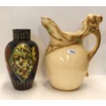 An Art Nouveau pottery ewer with maidens head handle (af) together with a Doulton Faience vase