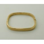 A 9ct gold bangle internal dimensions 6cm x 5.1cm, weight 13.1gms Condition Report: Available upon