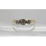 An 18ct and platinum three stone ring estimated approx diamond content 0.34cts, size U, weight