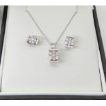 A 9ct white gold flower pendant and chain and a pair of matching earrings, set with estimated approx