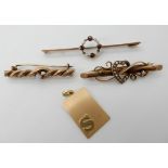 An 8ct gold opal set brooch, a 9ct garnet and pearl bar brooch, a 9ct pearl set heart brooch and a