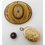A Victorian locket back brooch set with pearls and a red gem, 4.3cm, a bright yellow metal