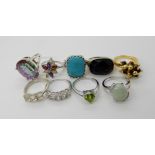 A collection of silver and white metal rings to include, mystic topaz, peridot, cz etc Condition