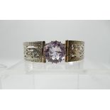 A silver Hamish Dawson - Bowman knotwork dragon bangle set with an amethyst Condition Report: Not