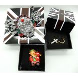 A collection of Butler & Wilson to include a mask statement bracelet, a teddy brooch and cross