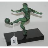 A 20th Century spelter figure of a footballer, kicking a football with left foot on black marble