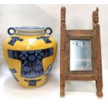 An oriental framed mirror with horse finials (one ear af) together with a large yellow ground jar