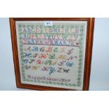 A Victorian framed sampler, Maggie Robson, 1879, 30 x 30cm framed and glazed Condition Report: