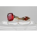A 9ct gold garnet and pearl ring size R and a red glass set 9ct Deco ring size L1/2 Condition