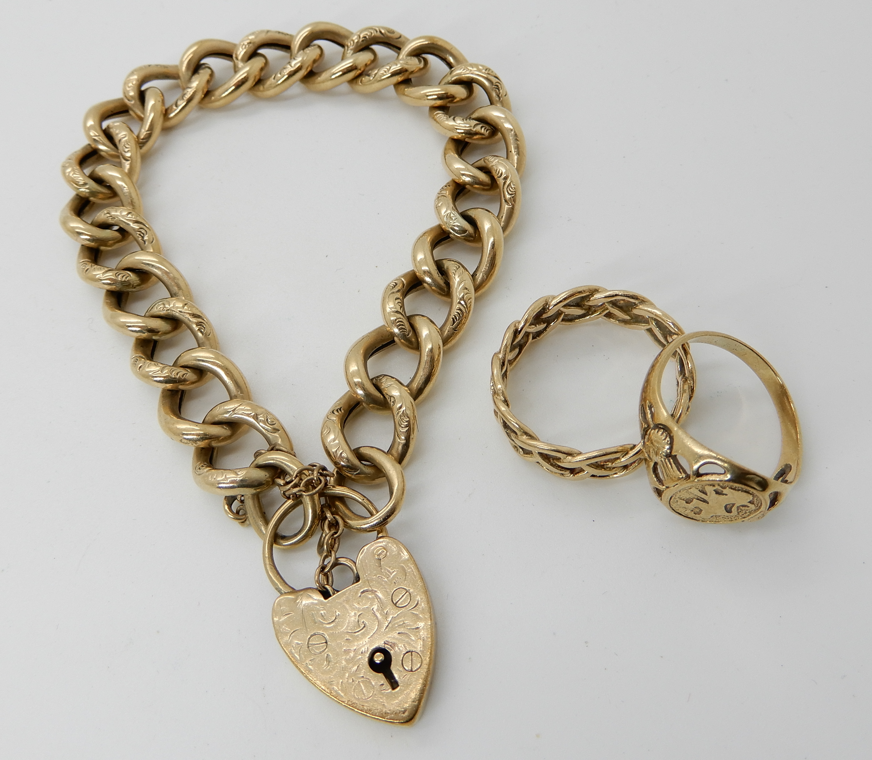 A 9ct gold engraved link curb bracelet with heart shaped clasp, length 19cm, a 9ct Celtic knotwork