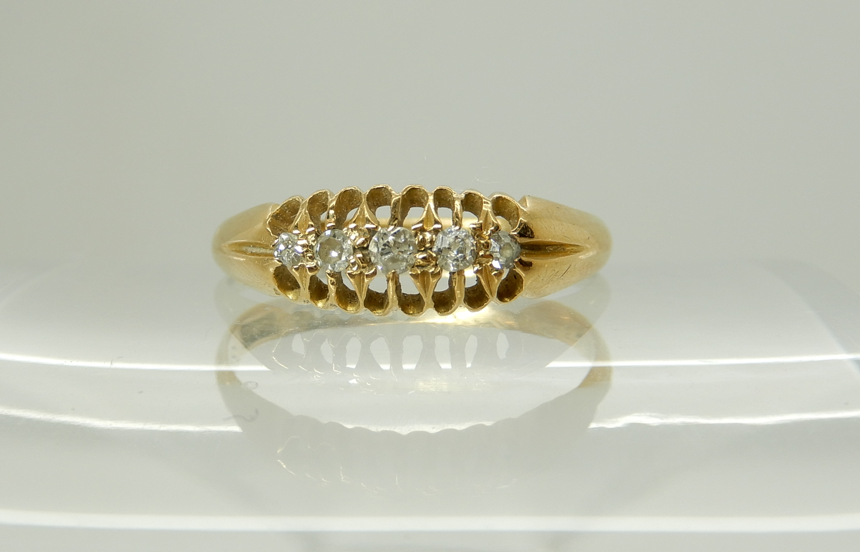 An 18ct gold five stone diamond ring, size P, weight 2.4gms Condition Report: Available upon