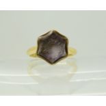 An 18ct gold intaglio engraved amethyst signet ring, carved with a Knights cross, hallmarked