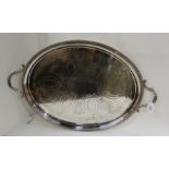 An oval silver plated twin handled serving tray with foliate engraving and gadrooned edge, 67cm