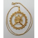 A 21k pendant depicting the National Emblem of Oman, weight 5.6gms, together with a 18ct box chain