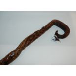 A carved early 20th Century walking cane with twisting serpent decoration and dated 1920 Condition