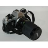 A Pentax 35mm camera with lens and flash Condition Report: Available upon request