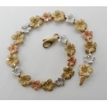 A 9ct three colour gold flower bracelet, length 18.5cm, weight 7.6gms Condition Report: Available