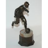 A spelter figure of a footballer on marble and spelter base, 23cm high Condition Report: Available