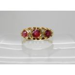 An 18ct gold ruby and diamond ring size N, largest ruby approx 4mm, smallest 3.4mm, diamonds rose
