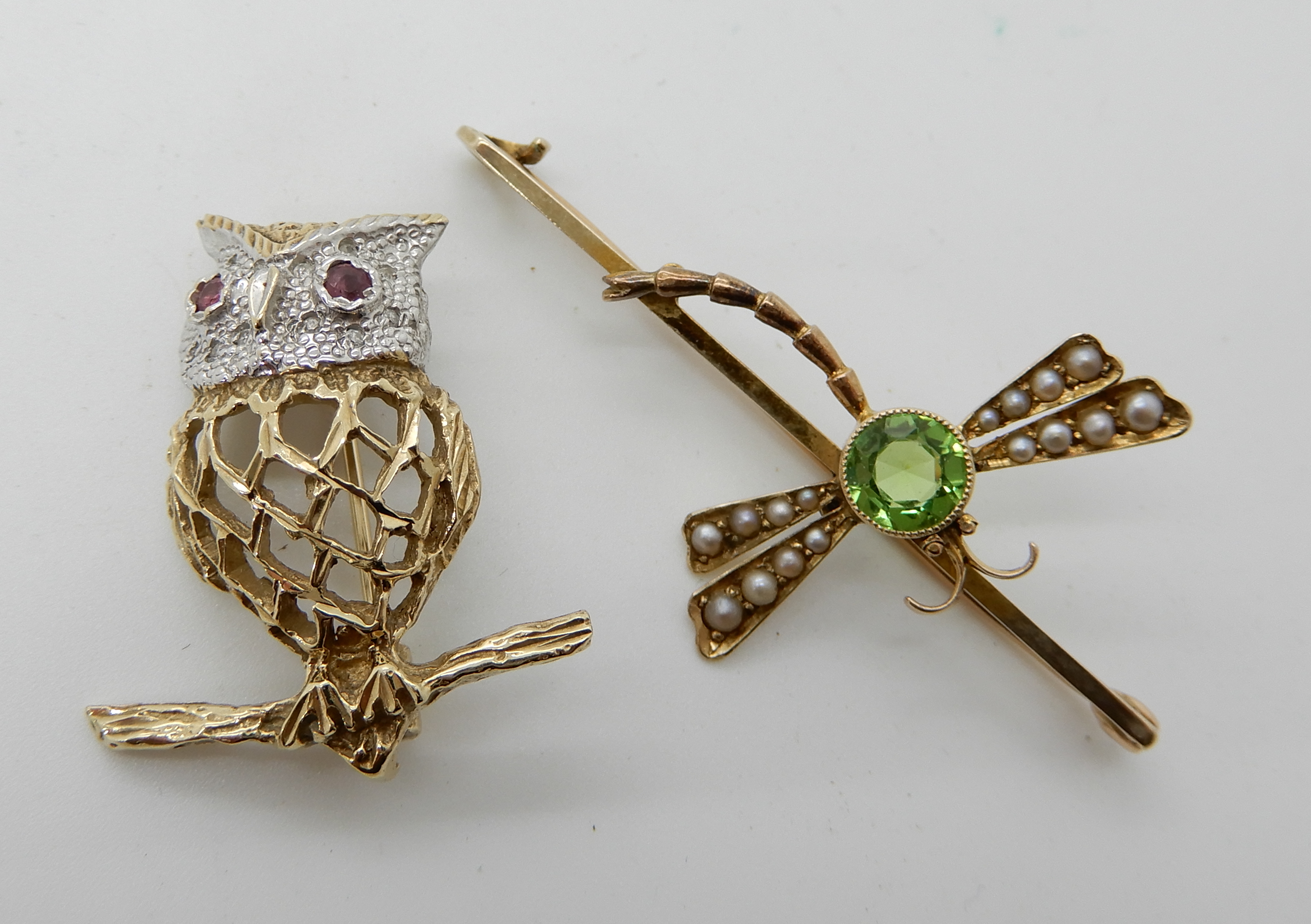 A 9ct gold diamond and ruby set owl brooch, length 3cm, together with a 9ct gold pearl and green gem