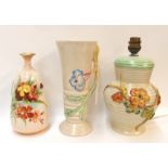 A Clarice Cliff moulded flower lamp base and vase and a nautilus porcelain vase Condition Report: