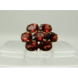 A 9ct gold garnet cluster ring, size N1/2, weight 4.5gms Condition Report: Available upon request