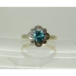 A bright yellow metal blue zircon and diamond flower ring, size J approx, weight 3.5gms Condition