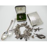 An extensive silver charm bracelet, a silver cigarette box, a silver Caithness glass ring and