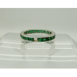 A white metal emerald full eternity ring (one stone missing) size N, weight 3.1gms Condition Report: