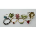 A collection of silver and white metal rings to include, peridot, apatite and a ring of roses ring