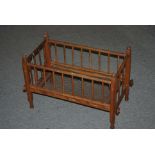 A doll's turned wood cot, 59 x 32cm Condition Report: Available upon request