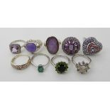 A collection of silver and white metal rings to include, apatite, lilac hardstone, ammolite etc
