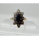 A yellow metal sapphire and diamond flower ring, size T1/2, weight 4.3gms Condition Report: