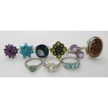 A collection of silver and white metal rings to include, druzy quartz, mystic topaz, peridot etc
