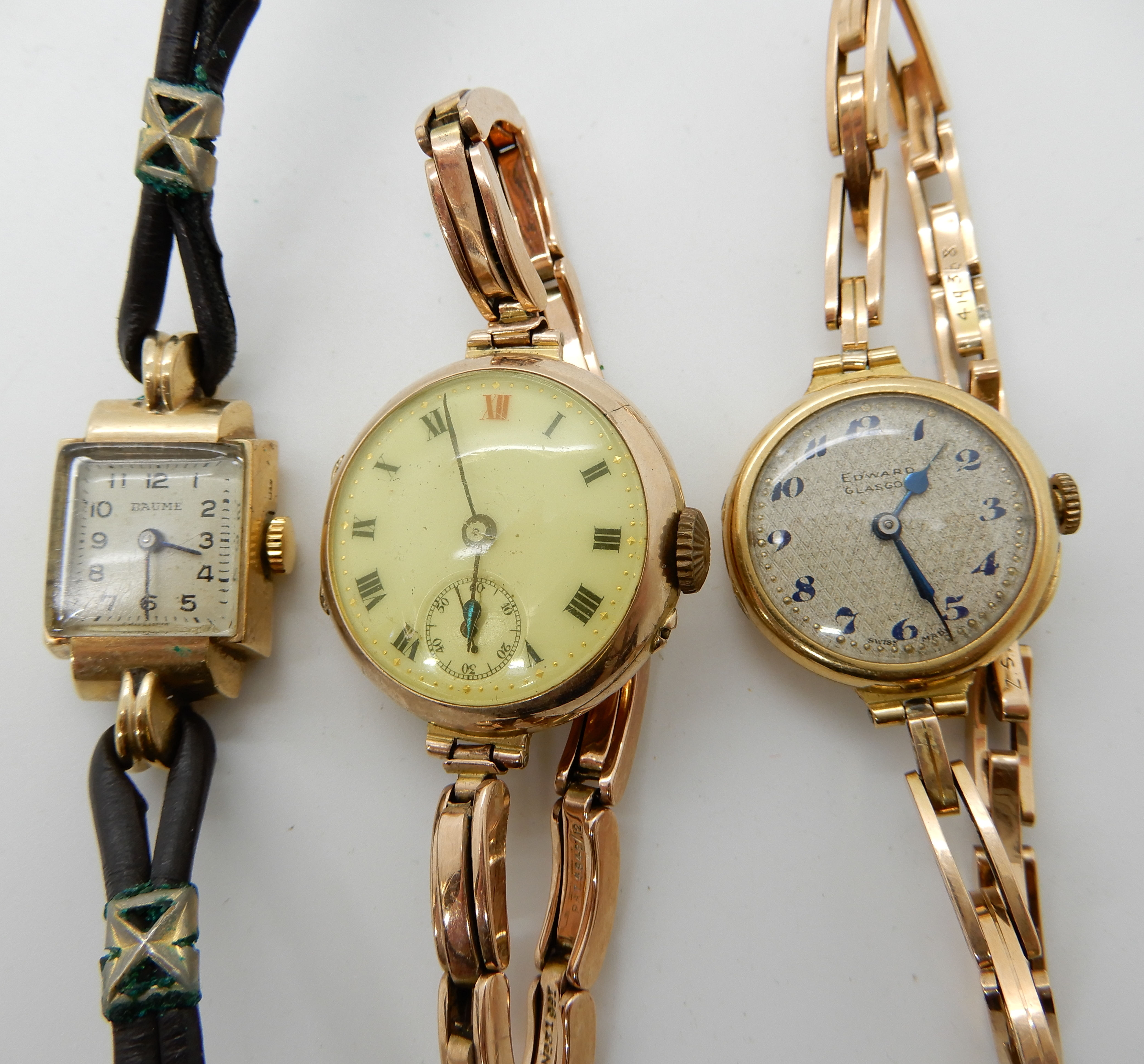 An 18ct cased ladies Edward of Glasgow watch with 9ct strap, a 9ct ladies vintage watch and strap