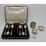 A lot comprising a cased set of six silver coffee spoons with tongs, Sheffield 1934 and three silver