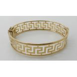 A 9ct gold Greek key pattern bangle, inner dimensions 6.5cm x 5.4cm, weight 14.5gms Condition