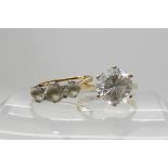 A 9ct gold clear gem set solitaire size M and a 9ct three clear gem set ring size M1/2, weight