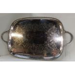A silver plated twin handled serving tray of rectangular form with foliate engraving and gadrooned