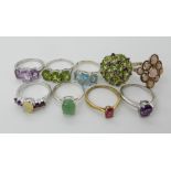 A collection of silver and white metal rings to include, peridot, amethyst, opal etc Condition