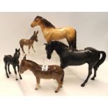 A Beswick donkey and foal, Black Beauty and foal and a Highland pony Condition Report: Donkey has